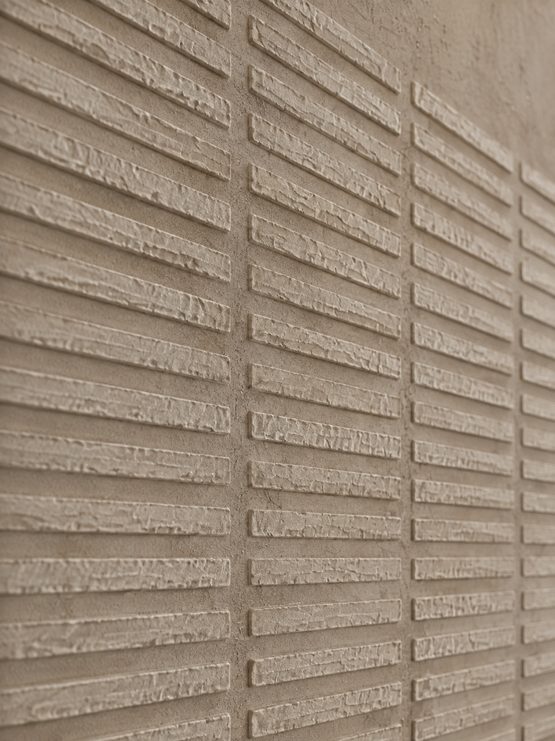 An angled close-up of a textured abstract painting, showing raised surface detail.