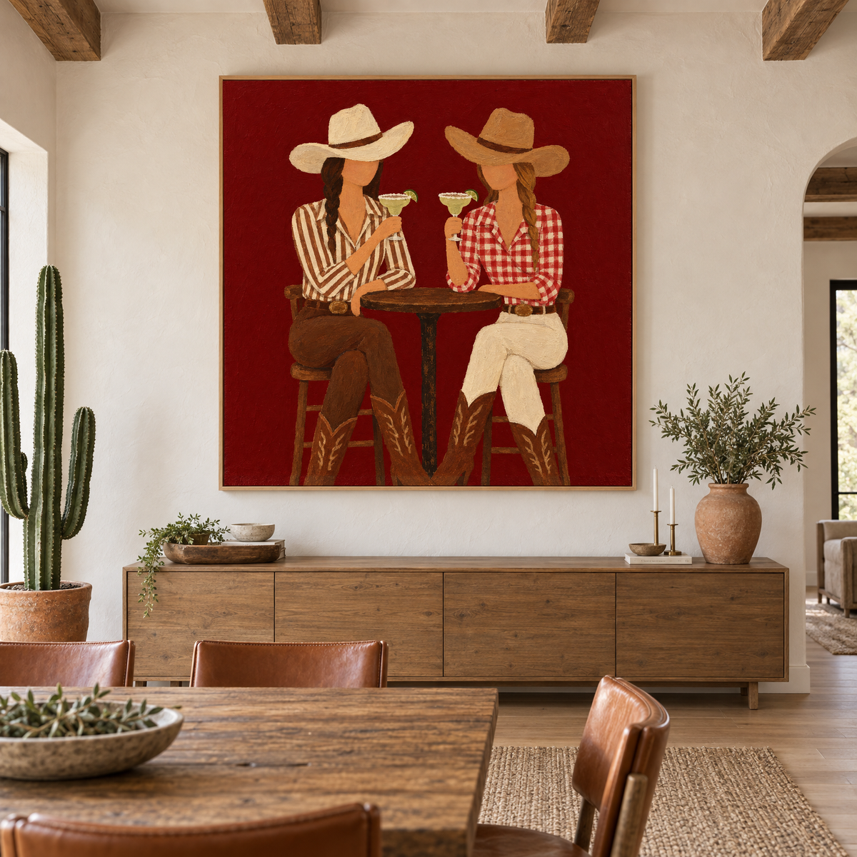 Oversized 72x72 inch western folk art oil painting of two cowgirls toasting margaritas above a sideboard in a modern ranch-style dining room