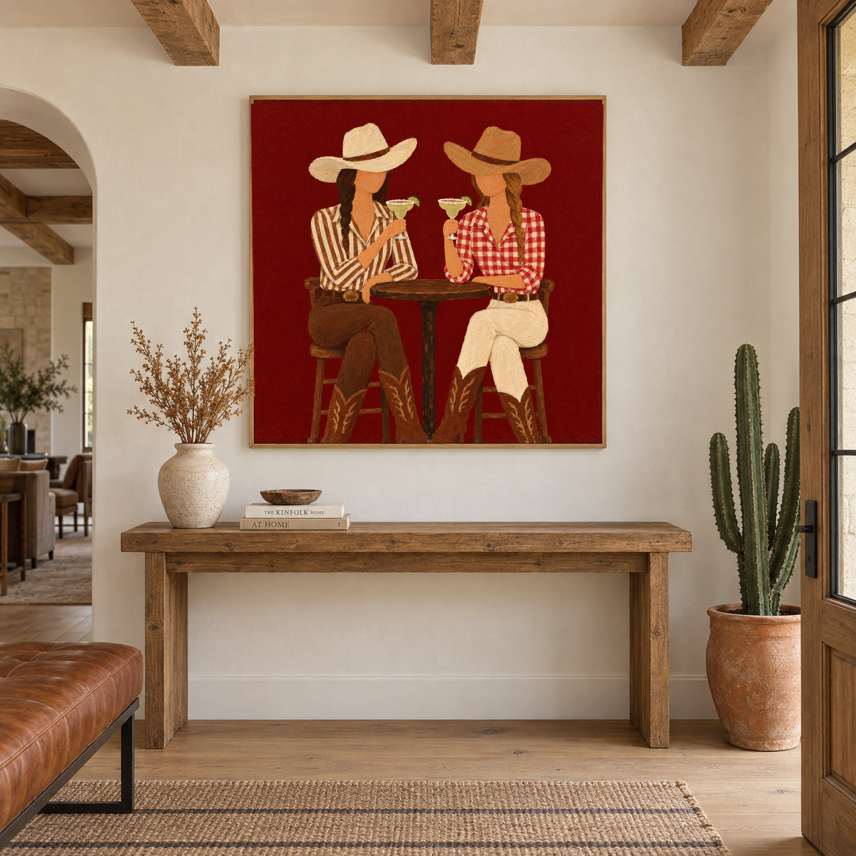 40x40 inch western folk art oil painting of two cowgirls toasting margaritas above a console table in a modern ranch-style entryway